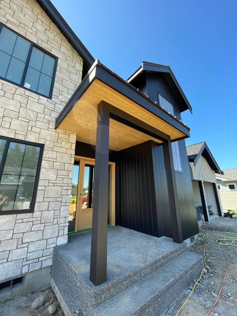 Modern dark-tone home in Blaine with stone and wood accents